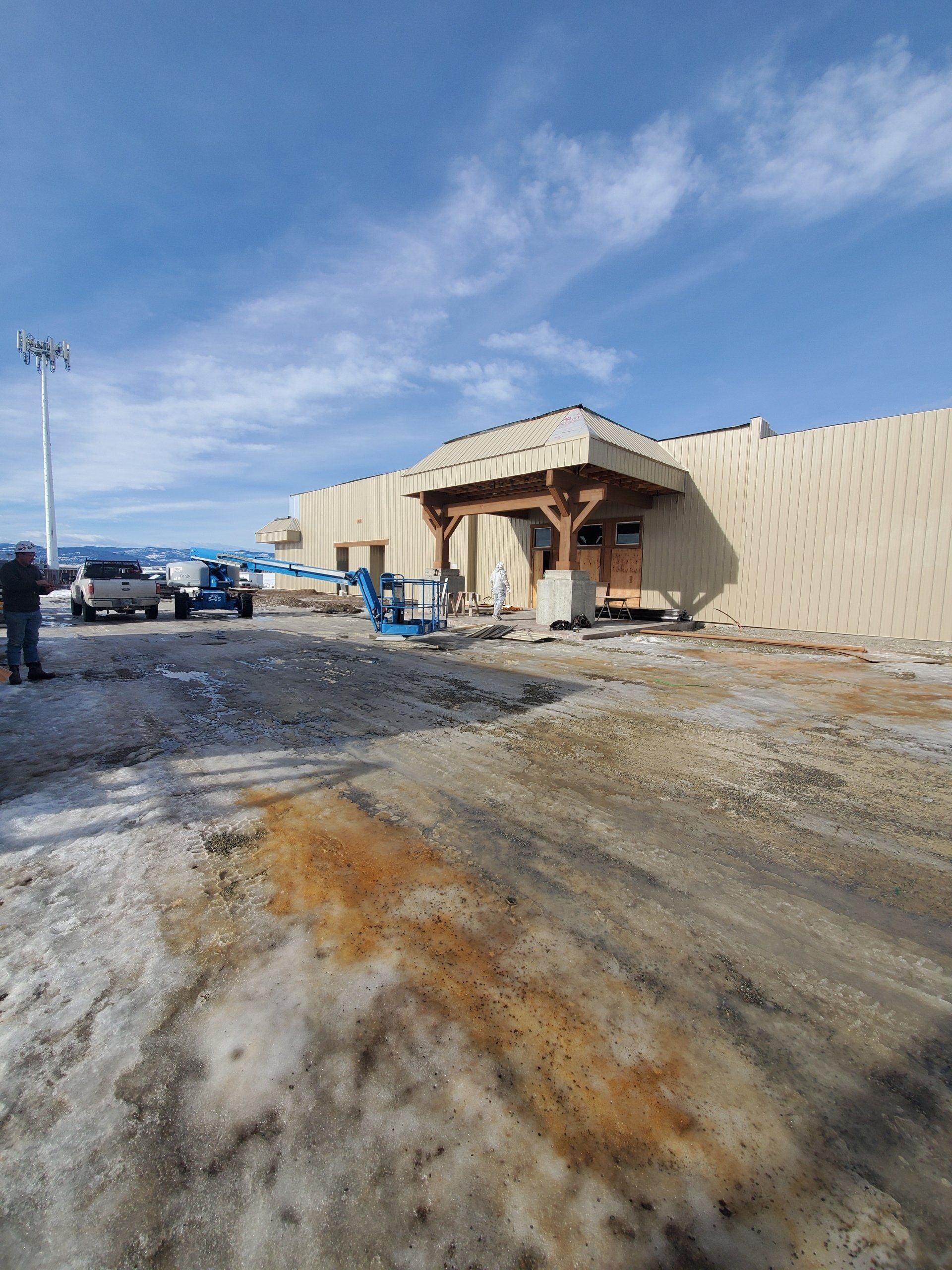 A large building is being built in the snow.