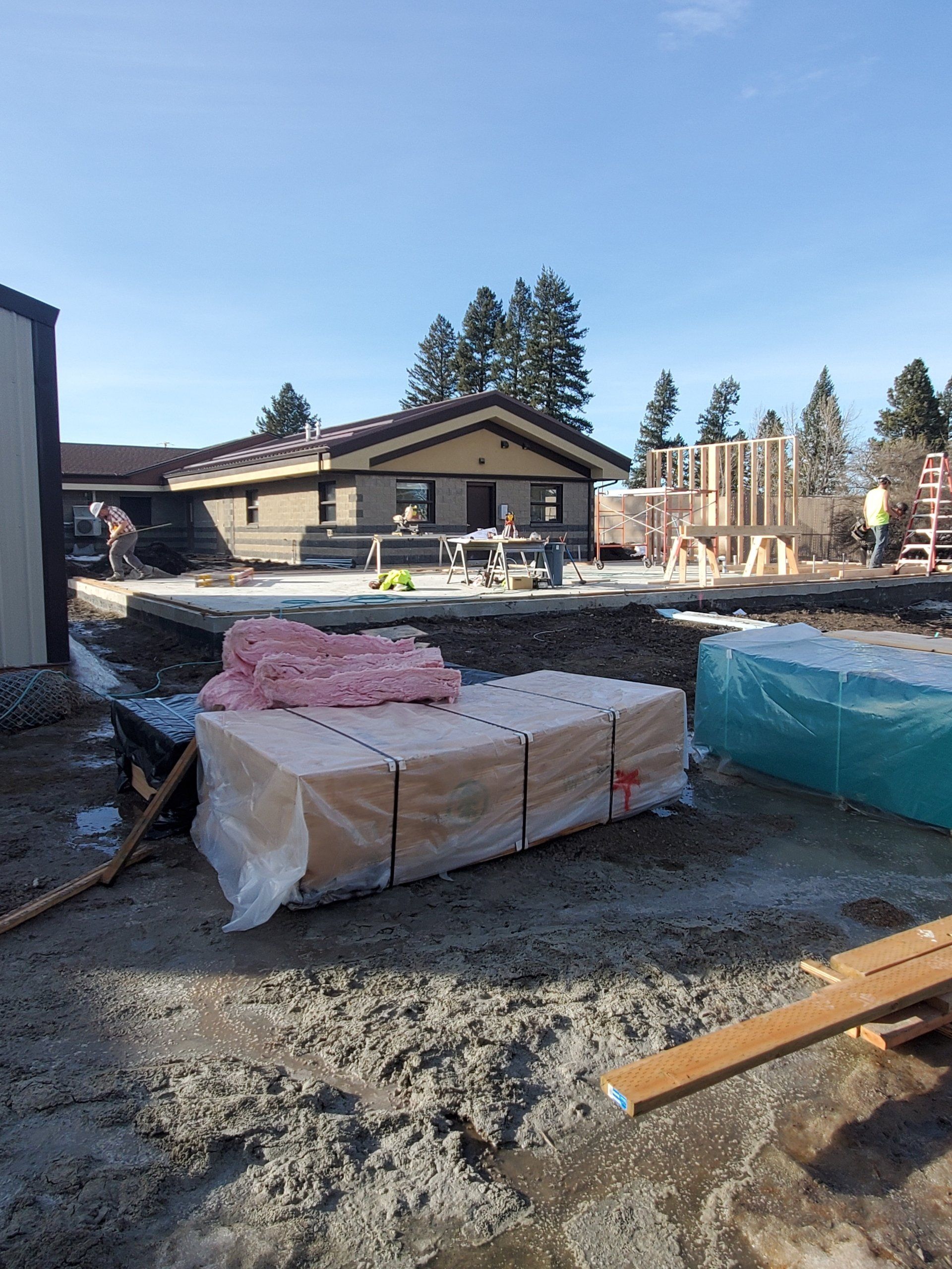A house is being built in the background and there is a lot of foam on the ground.