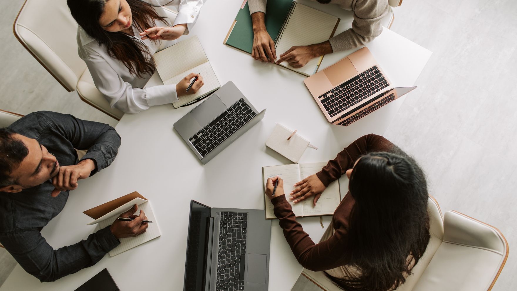 Team sitting at a table on their computers