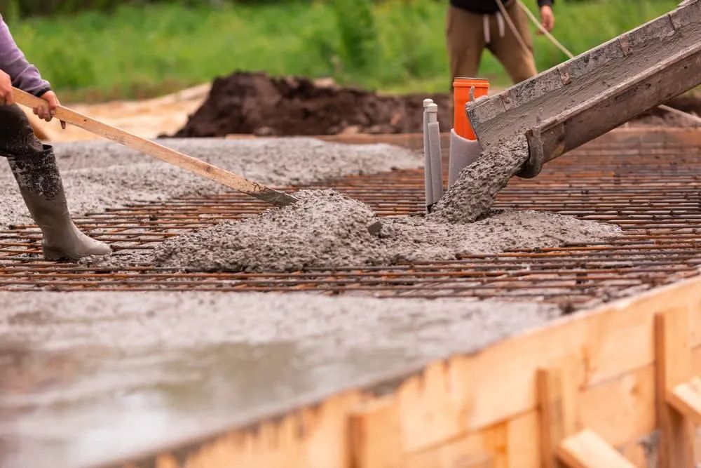 A Man is Pouring Concrete Into a Concrete Foundation —  A & B Mullins Excavations Pty Ltd in Bungadoo, QLD