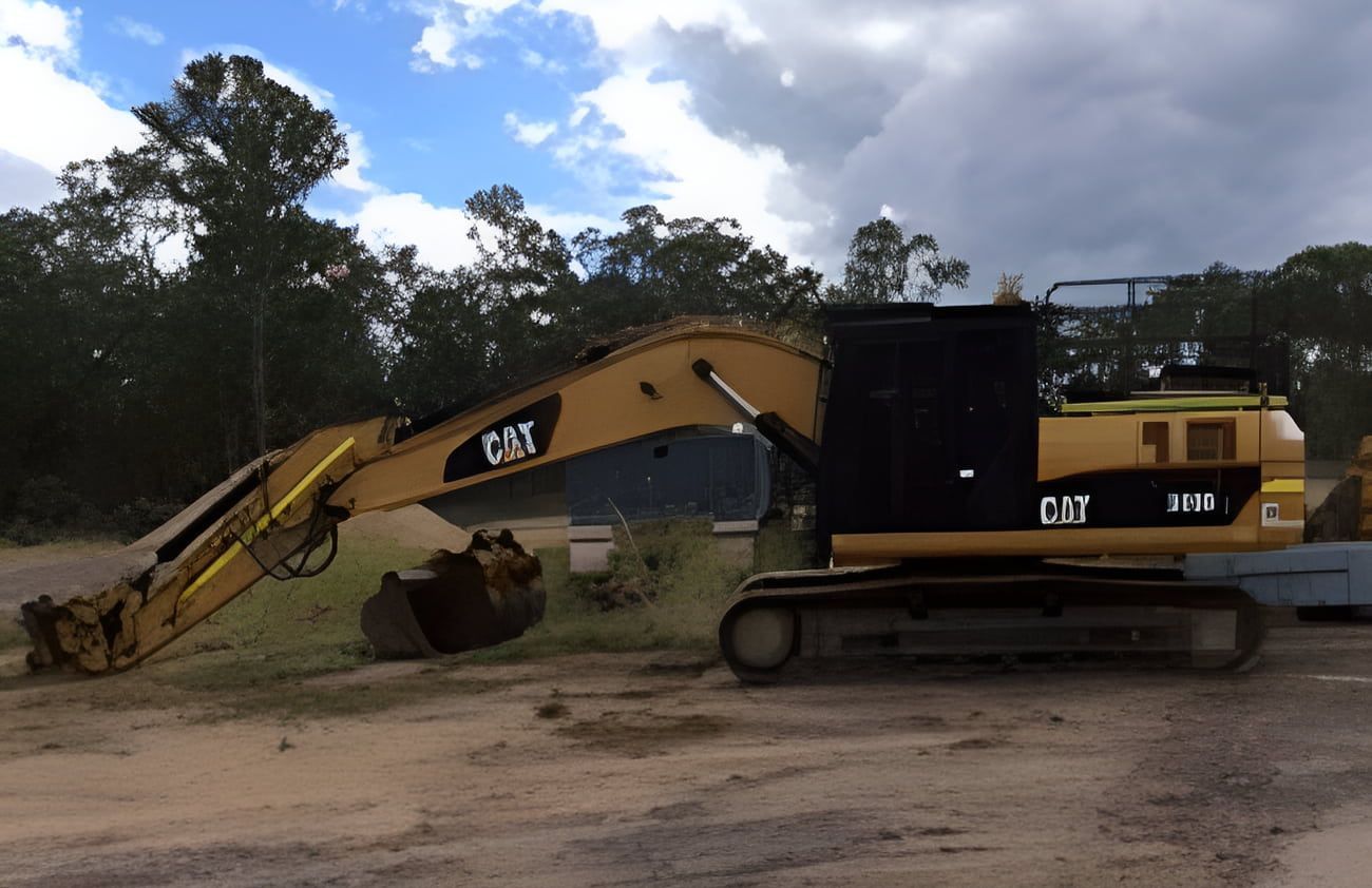 A Yellow and Black Cat Excavator is Parked in a Dirt Field — A & B Mullins Excavations Pty Ltd in Bundaberg, QLD