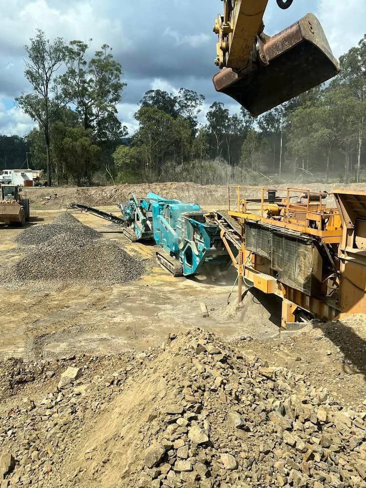 A Construction Site With a Lot of Machinery and Trees in the Background — A & B Mullins Excavations Pty Ltd in Bungadoo, QLD