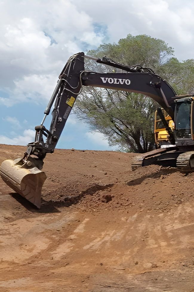 a Volvo Excavator is Digging a Hole in the Dirt — A & B Mullins Excavations Pty Ltd in Bungadoo, QLD