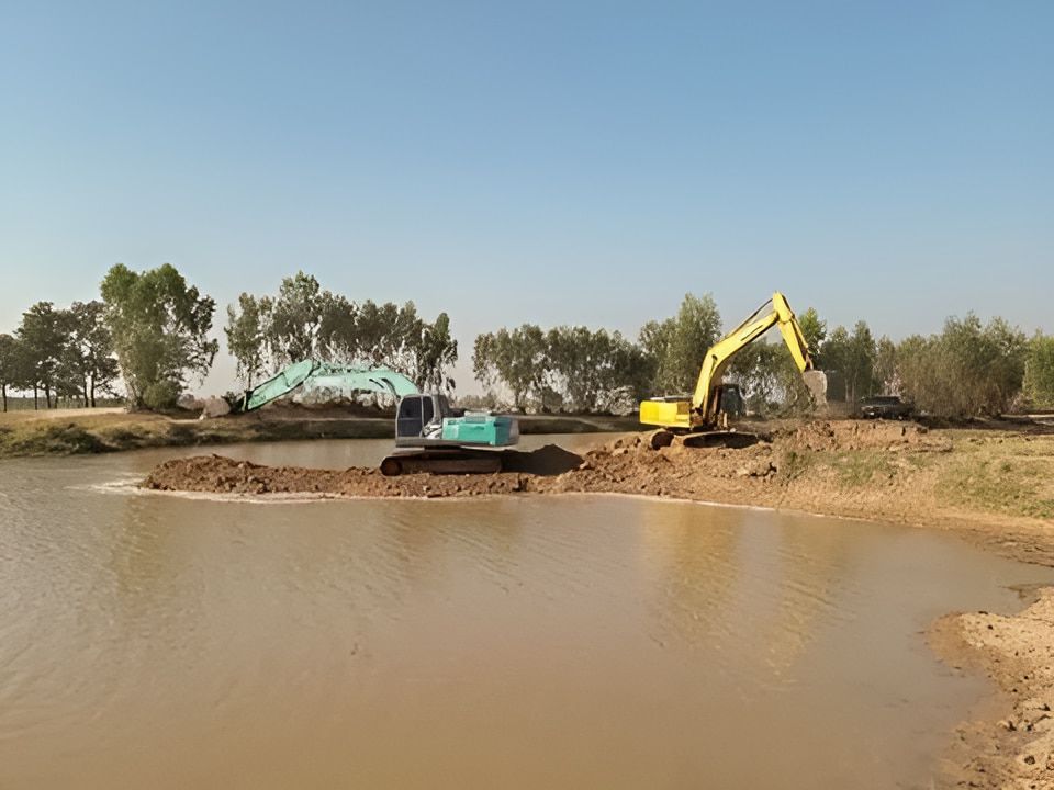 Two Excavators Are Working on a Body of Water — A & B Mullins Excavations Pty Ltd in Bundaberg, QLD