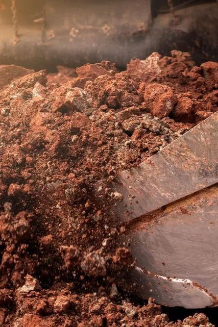 A Shovel is Digging Into a Pile of Dirt —  A & B Mullins Excavations Pty Ltd in Bungadoo, QLD