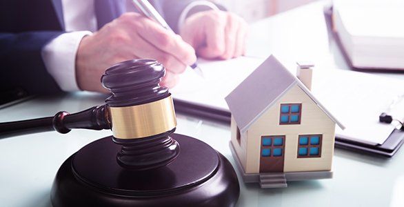House model with gavel in front of a lawyer — Downers Grove, IL — DMM Law Offices House model with gavel in front of a lawyer — Downers Grove, IL — DMM Law Offices