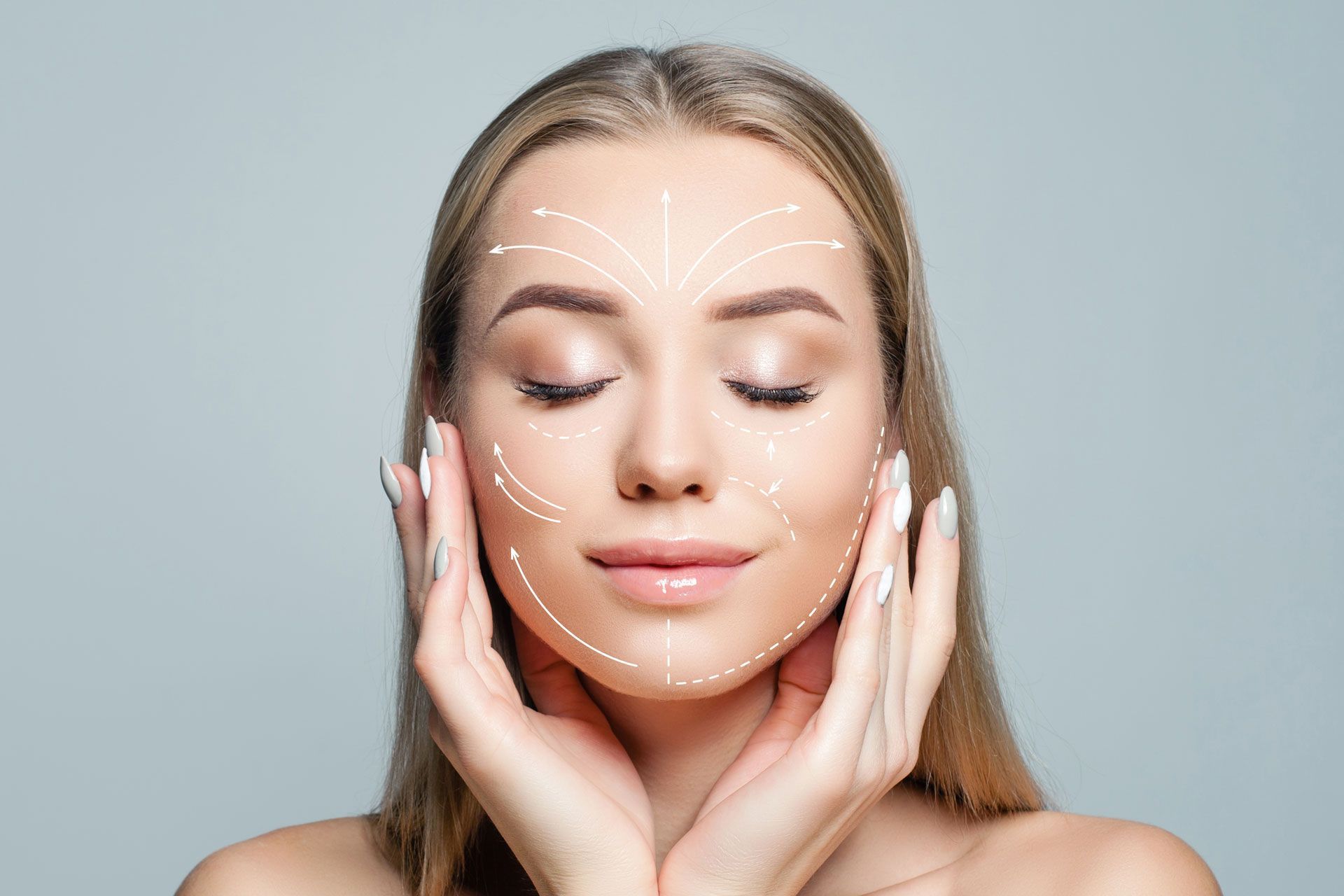 A person with eyes closed touches their face, which is marked with white lines indicating facial massage or lift paths.
