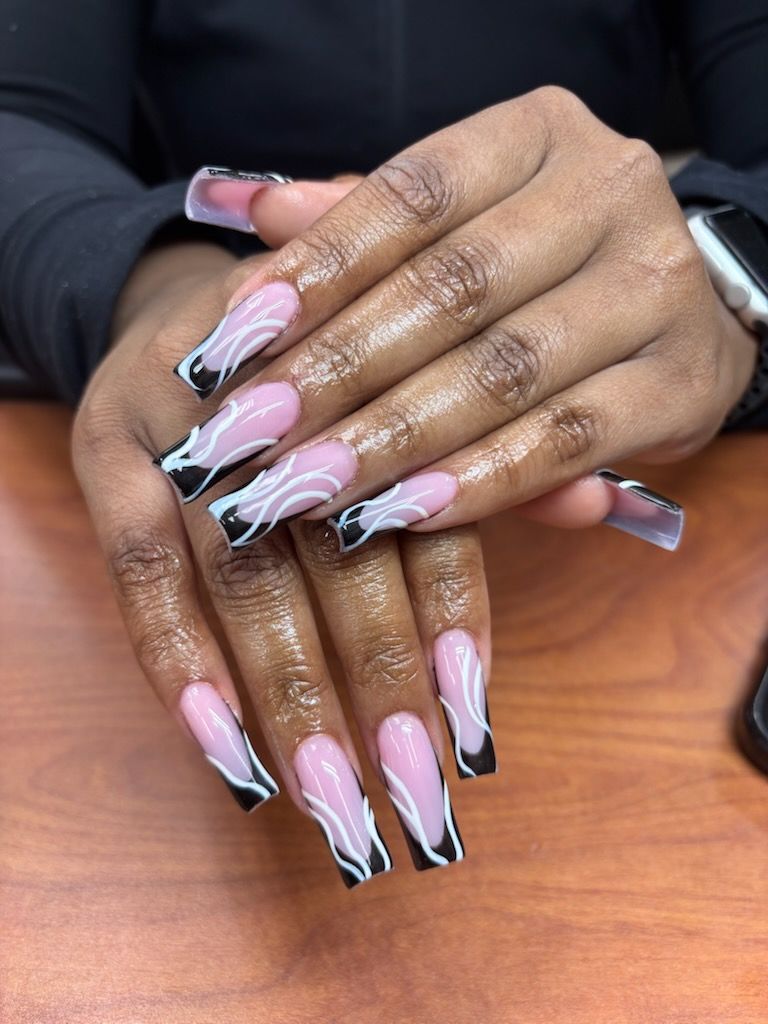 Long square nails with a nude base and black-and-white wavy, abstract line art at the tips.