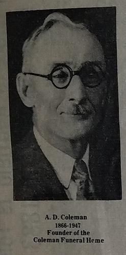 Portrait of A.D. Coleman, founder of the Coleman Funeral Home. He wears glasses, a suit, and tie.