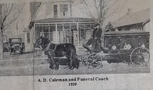 Black and white photo: Horse-drawn hearse in front of a house, 1920. Caption: A. D. Coleman and Funeral Coach.