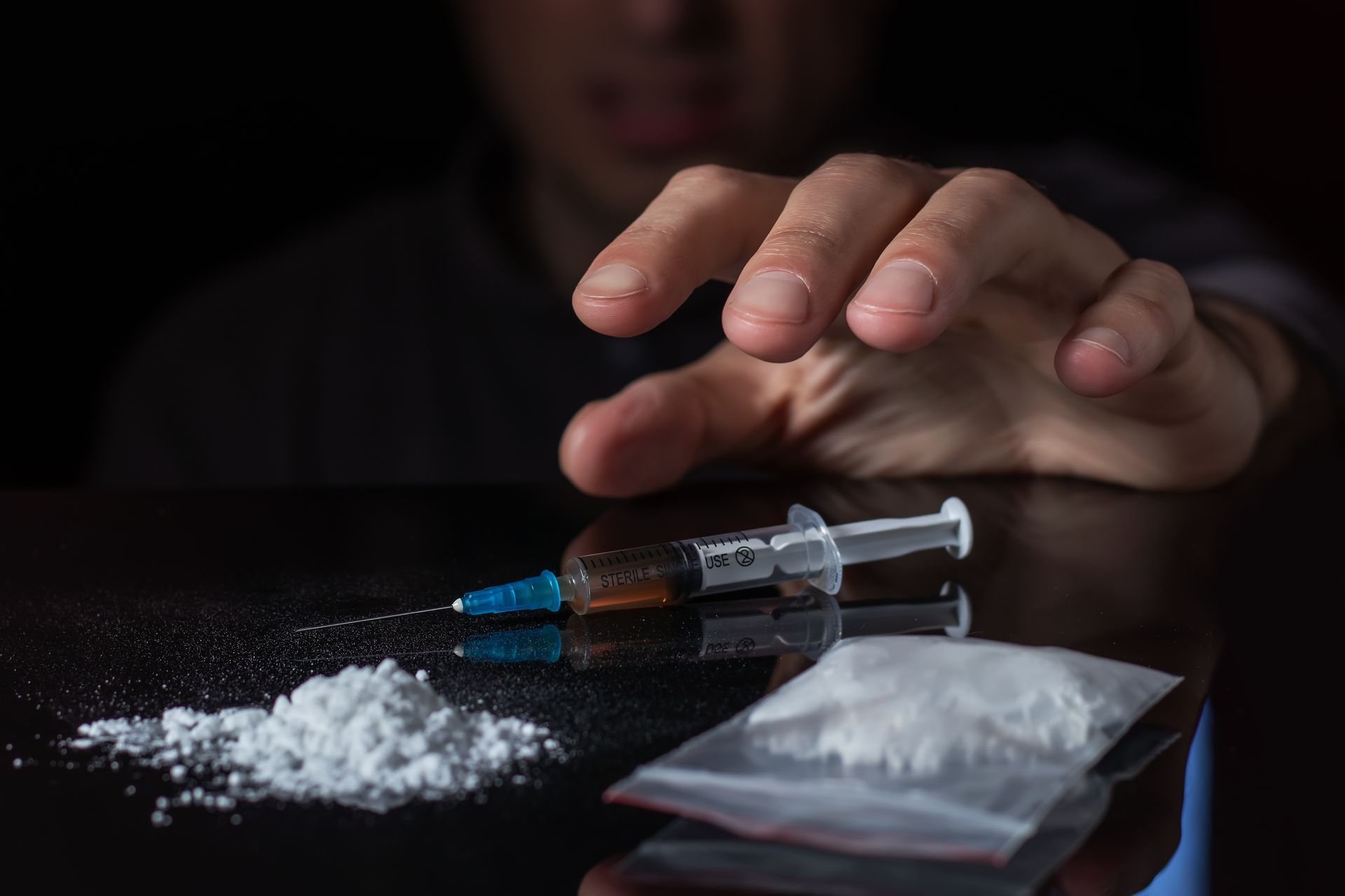 The text depicts a man who is using drugs.