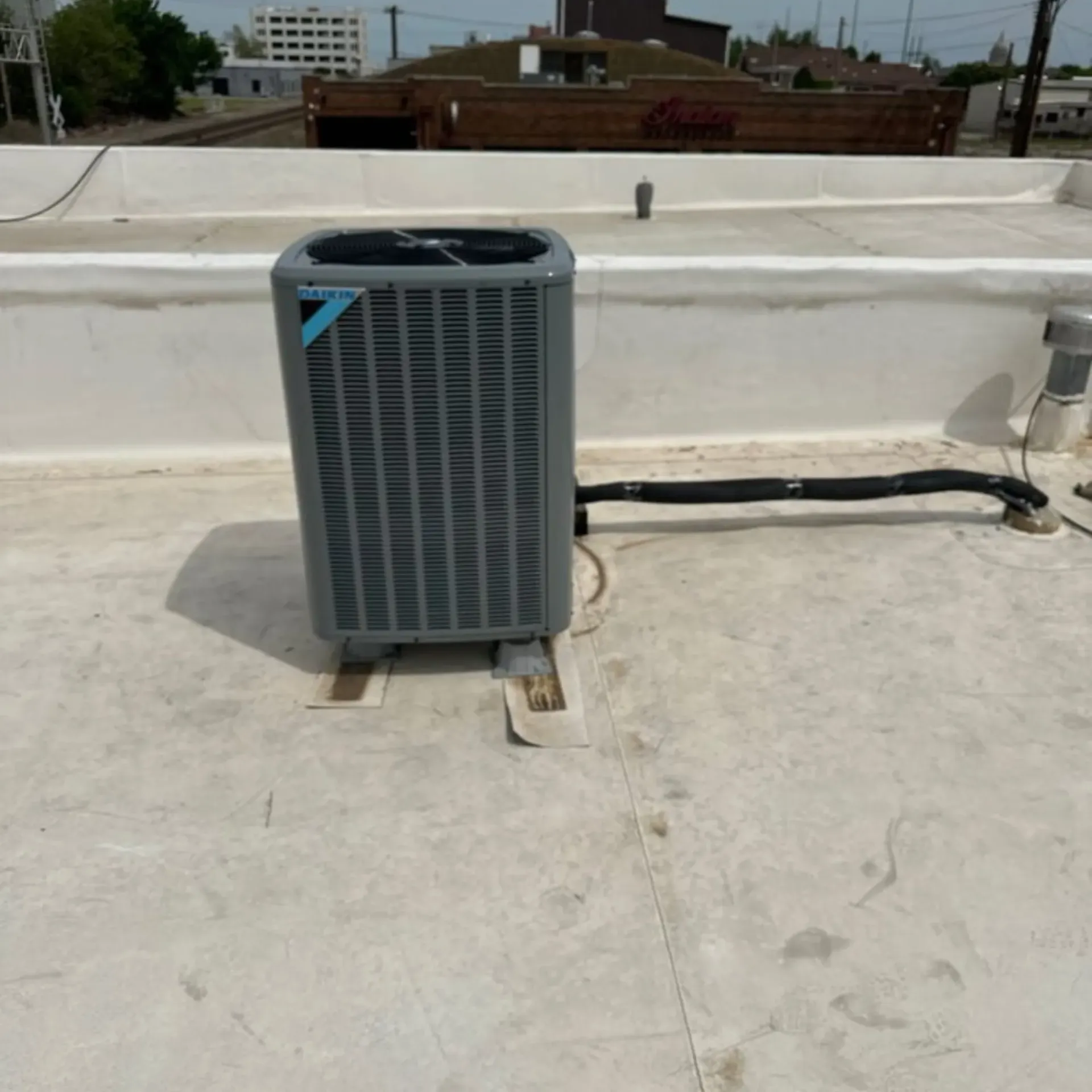 Finnegan’s Heating Air Conditioning - A daikin air conditioner is on the roof of a building