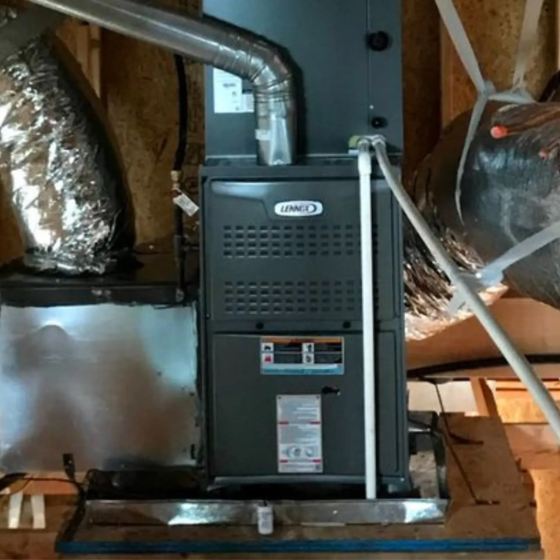 Finnegan’s Heating Air Conditioning - A lennox furnace is sitting in the attic