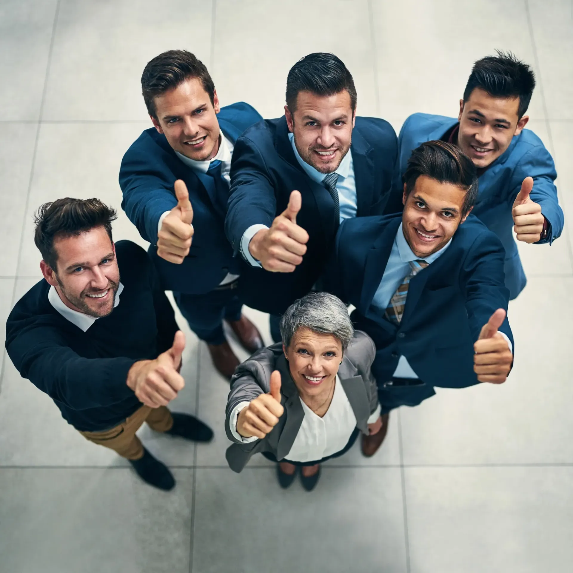 Finnegan’s Heating Air Conditioning - A group of people in suits are giving a thumbs up