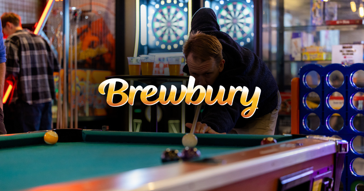 People playing pool in a neon-lit brewery with darts boards in the background.