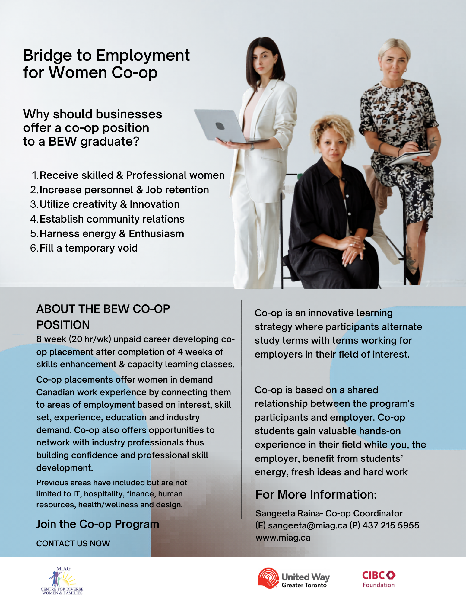 A group of women are standing around a table in an office.