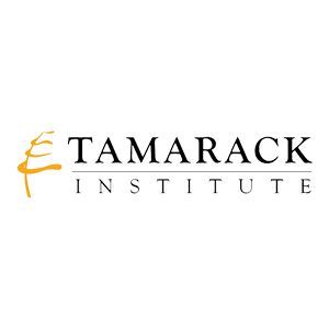 The logo for the tamarack institute is black and yellow