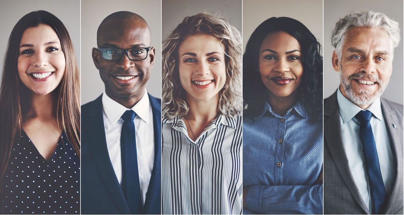 Five professionals smiling in a row, each shown in a narrow portrait panel against a neutral background.