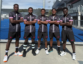 A team of players standing and crouching to take a picture