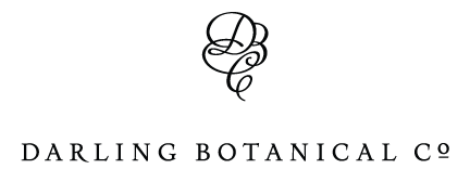 Darling Botanical Co logo with a decorative black monogram above the company name on a white background