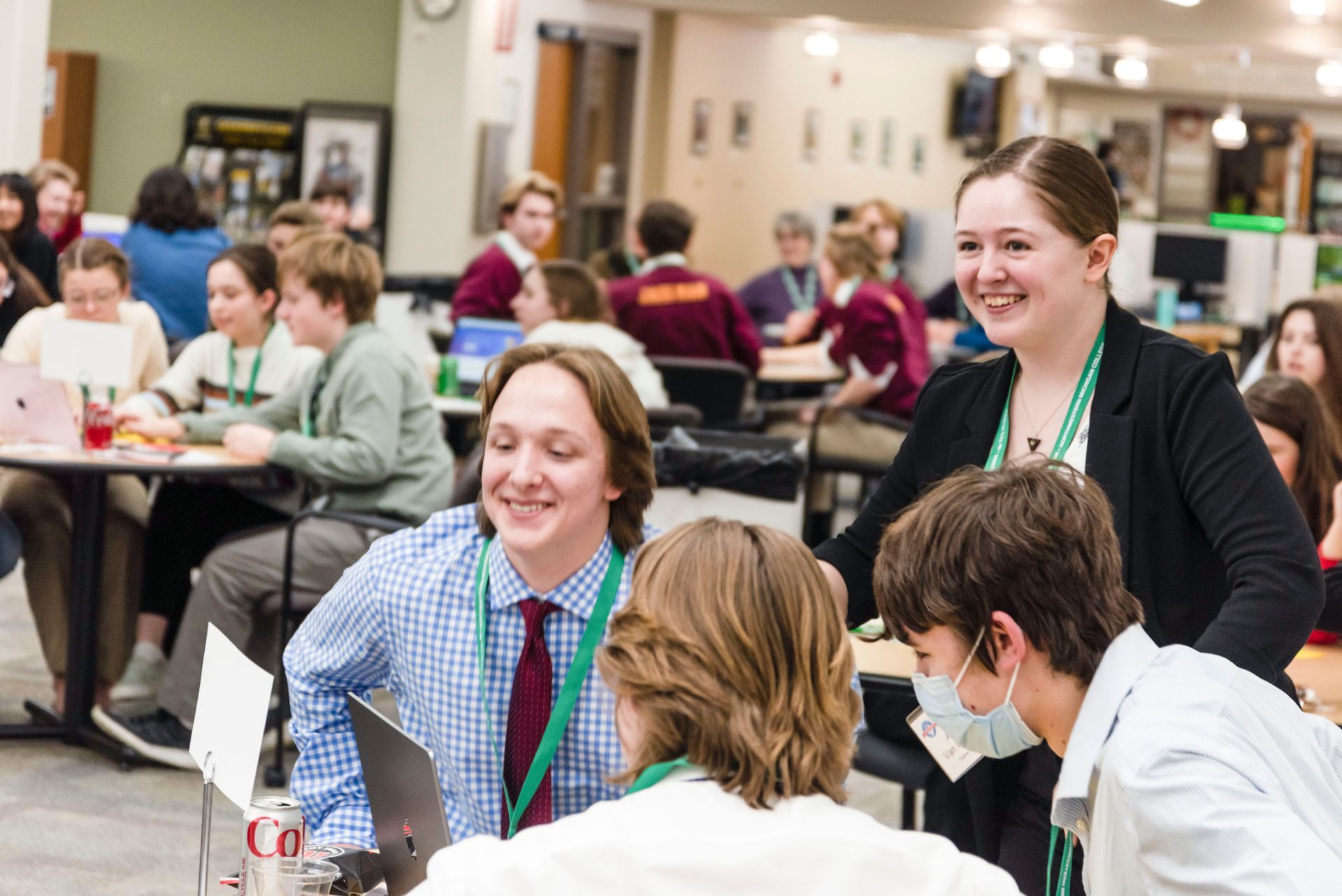 A group of people are sitting at tables in a room.