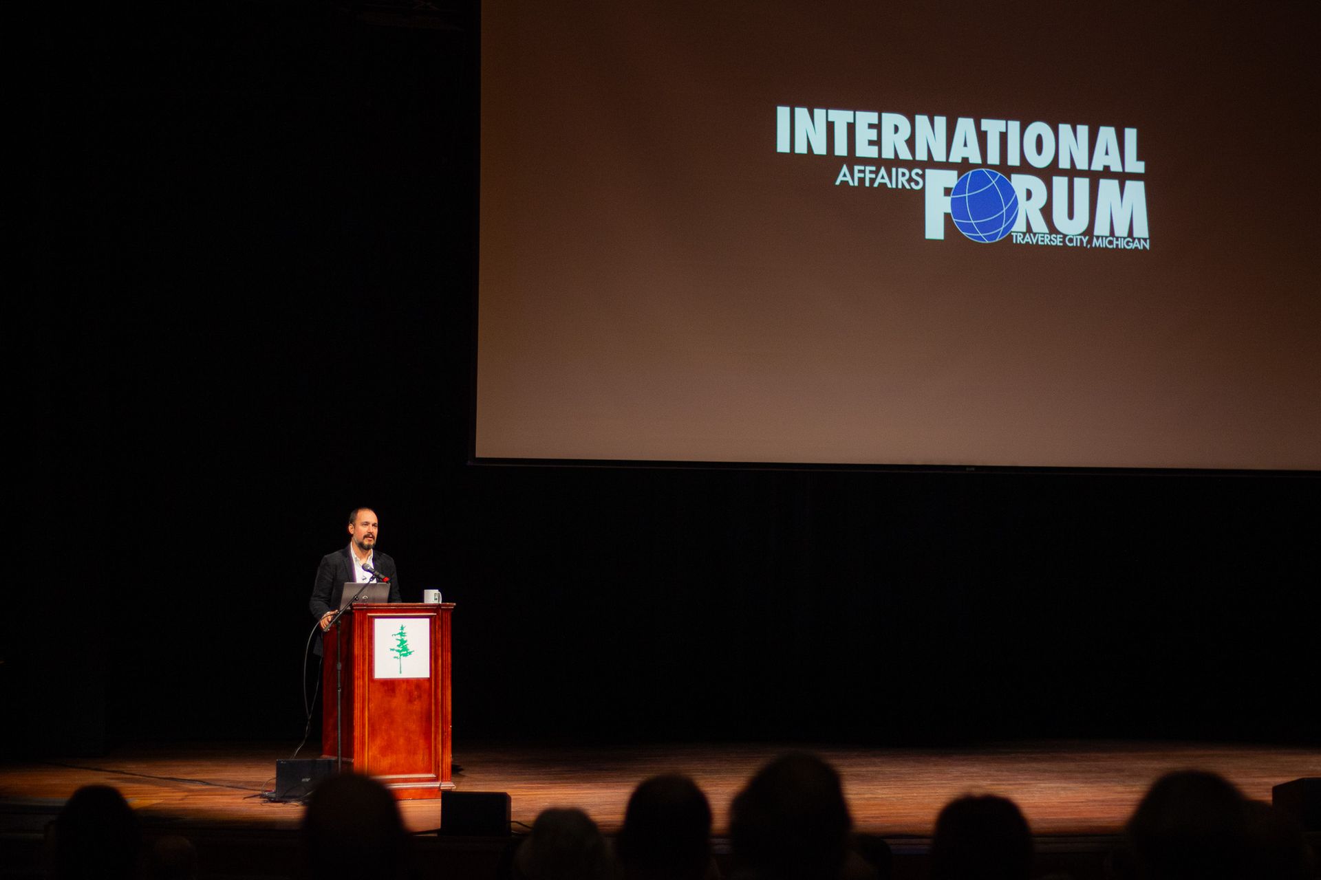 A man is giving a speech at the international forum