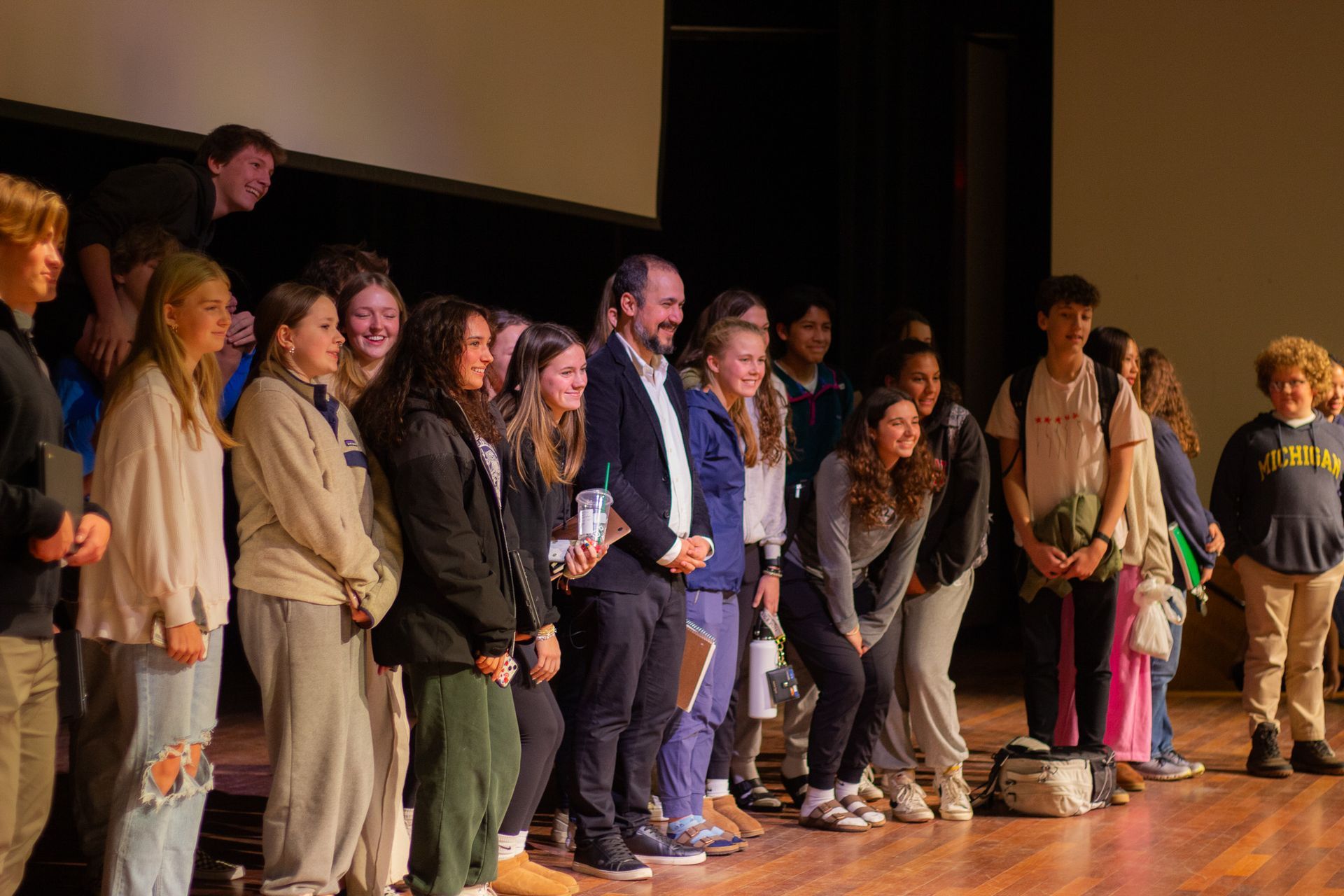 A group of people are posing for a picture on a stage.
