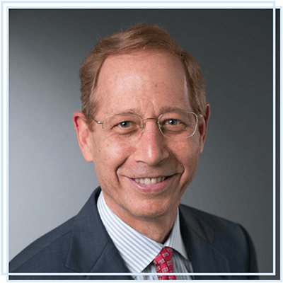 A man in a suit and tie is smiling for the camera.