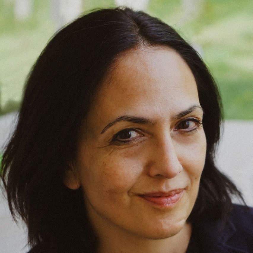 A close up of a woman 's face with a smile on her face