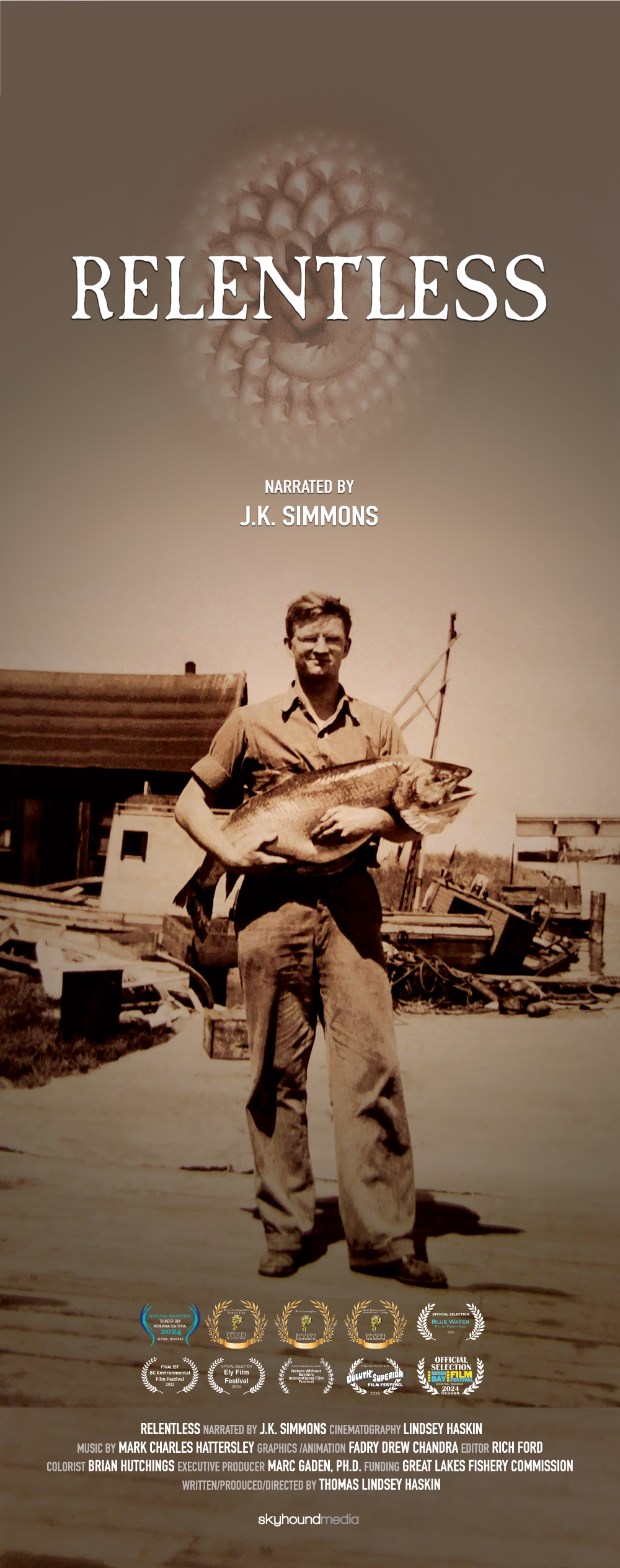 A man is holding a large fish in his arms on a movie poster for relentless.