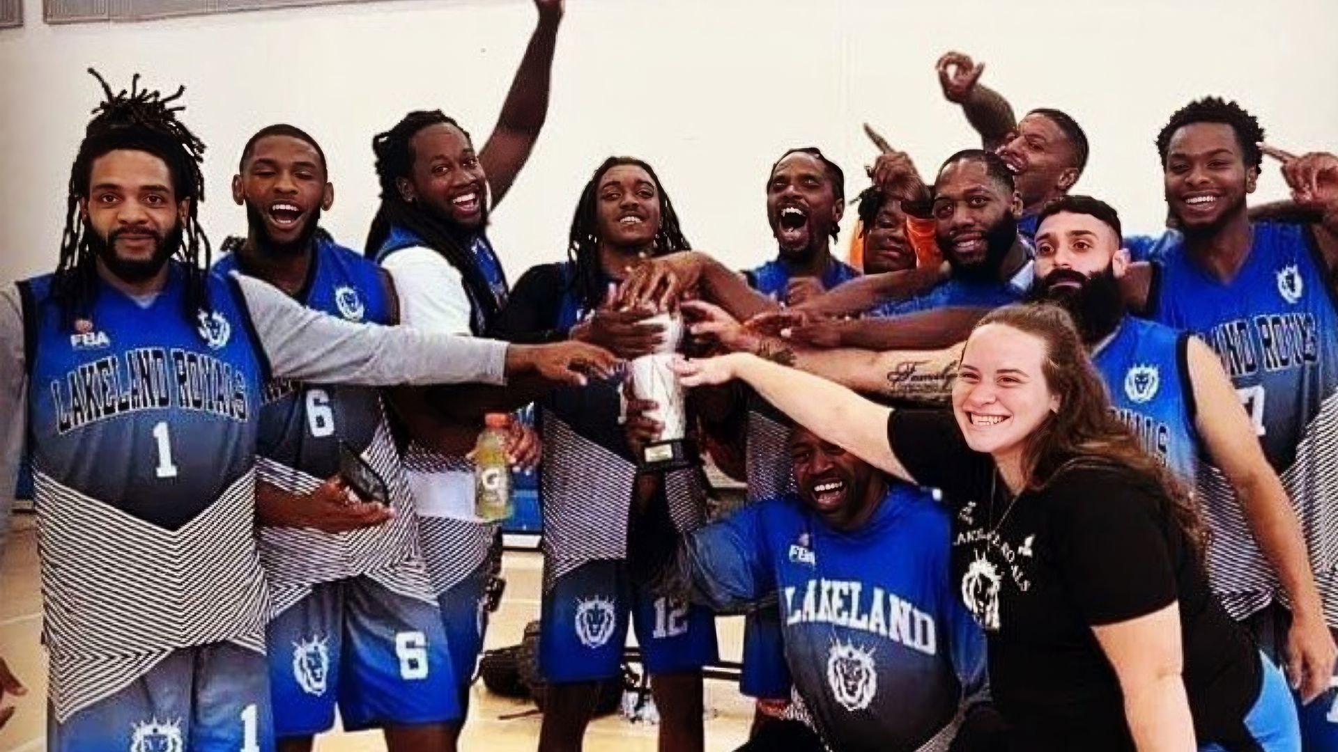 A group of basketball players are posing for a picture.