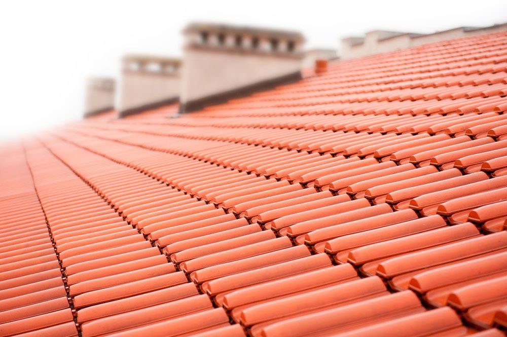A Close Up of a Tiled Roof With Chimneys in the Background — SRV Roofing in Noosa, QLD