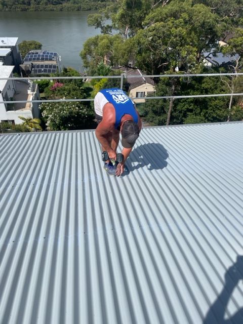 Worker Removing Roof Tiles — SRV Roofing in Gympie, QLD