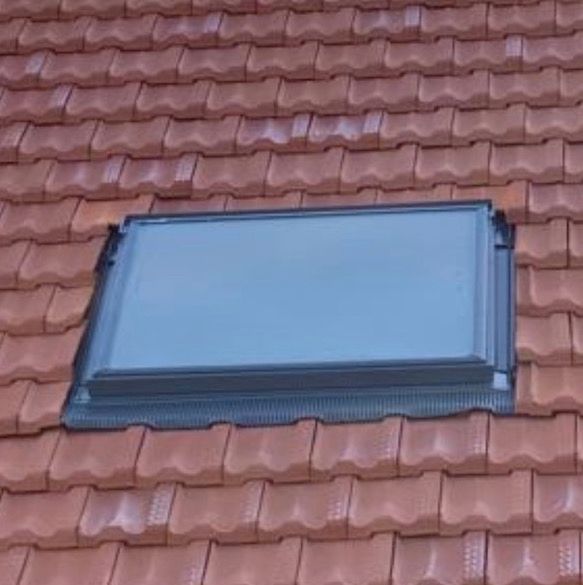 A Skylight on Top of a Red Tiled Roof — SRV Roofing in Coolum Beach, QLD