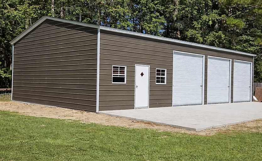 Brown garage with white double doors and a side entry door beside a driveway and lawn