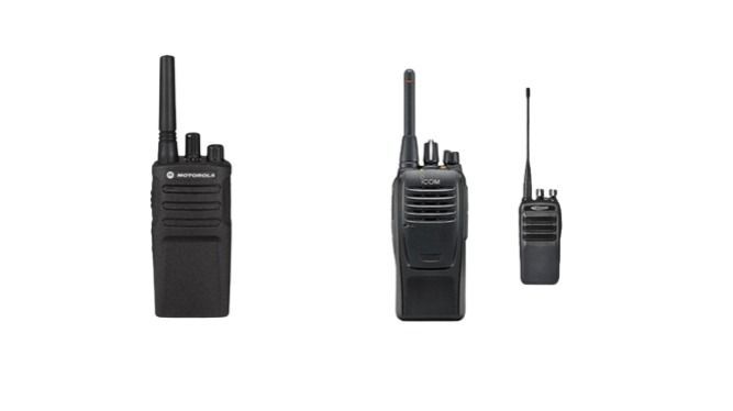 Three walkie talkies are sitting next to each other on a white background.