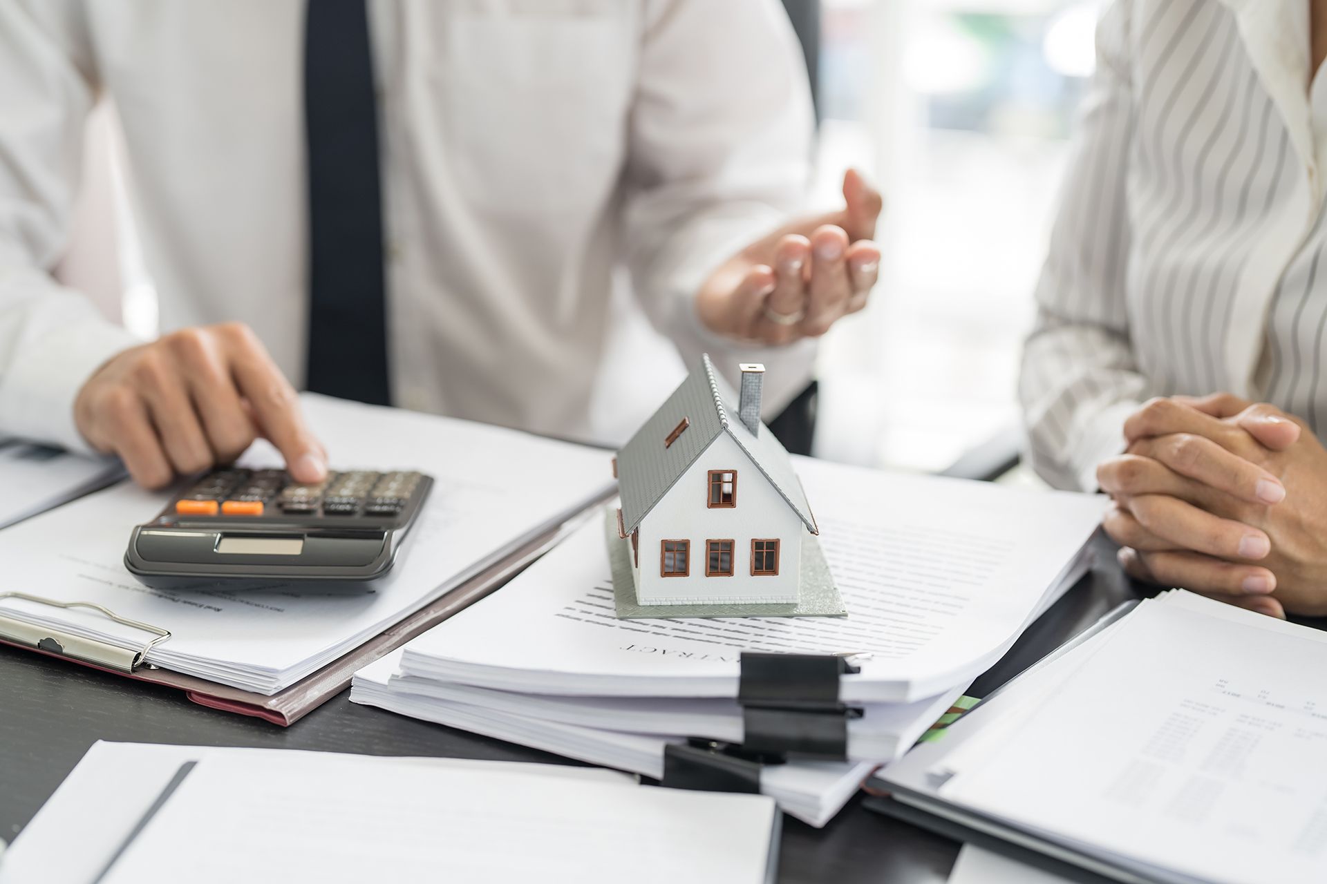 Real Estate Agent Using a Calculator