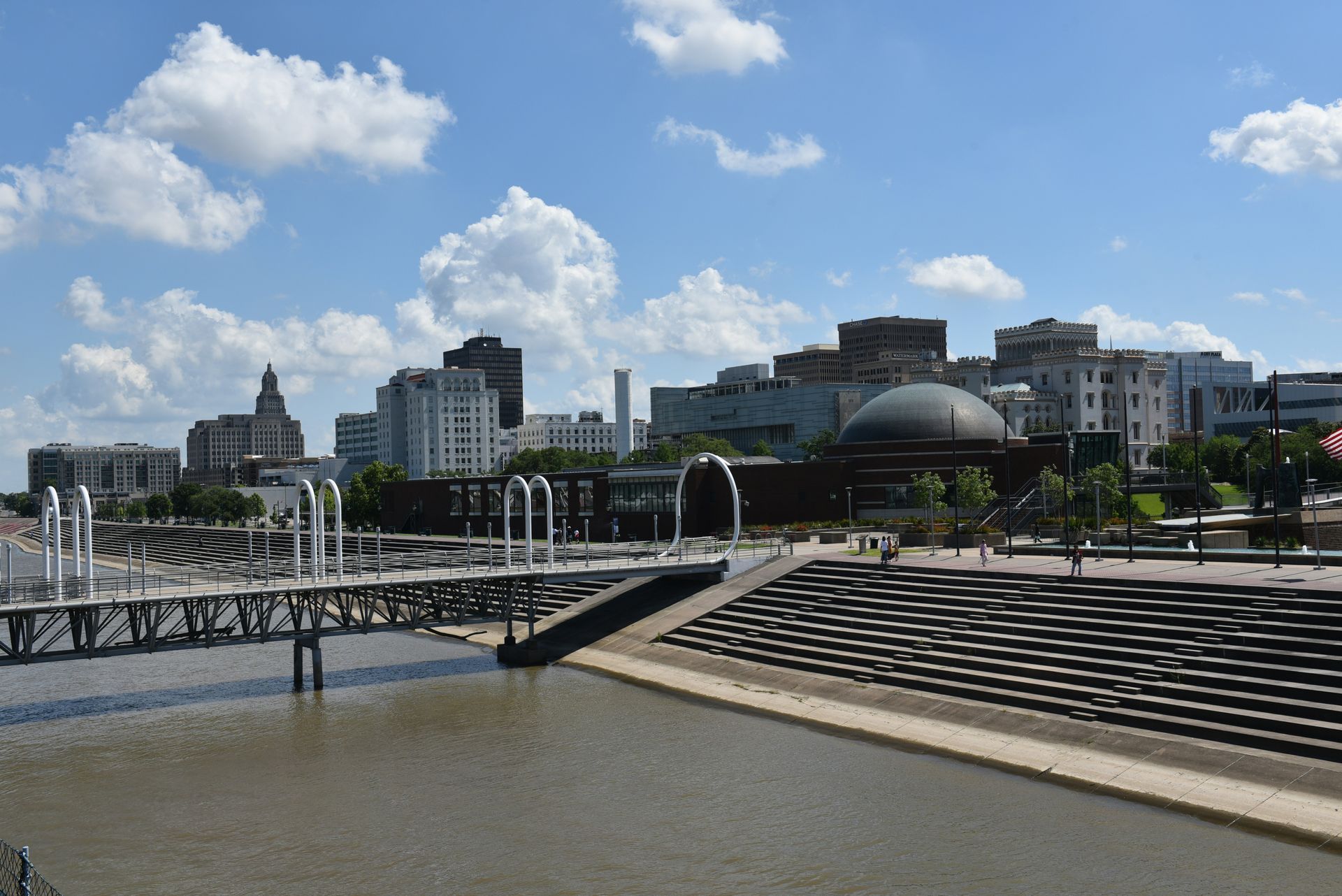 A bridge over a body of water with a city in the background