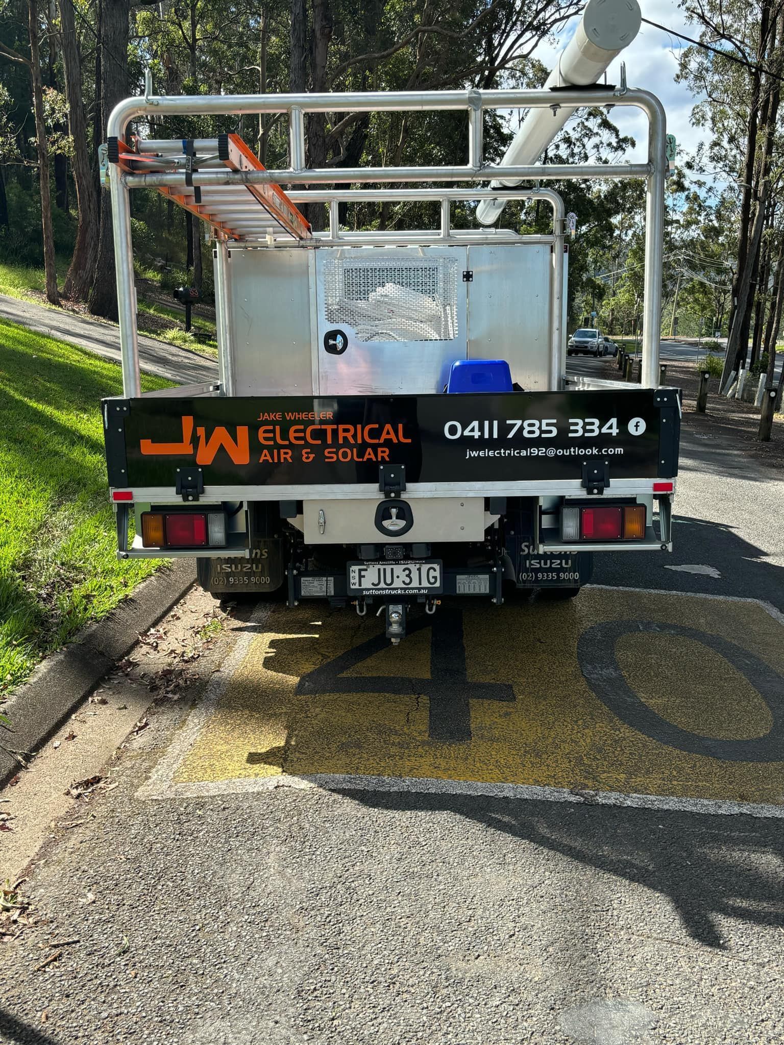 The back of an electrical truck is parked on the side of the road. — JW Electrical, Air & Solar Pty Ltd in Kew, NSW