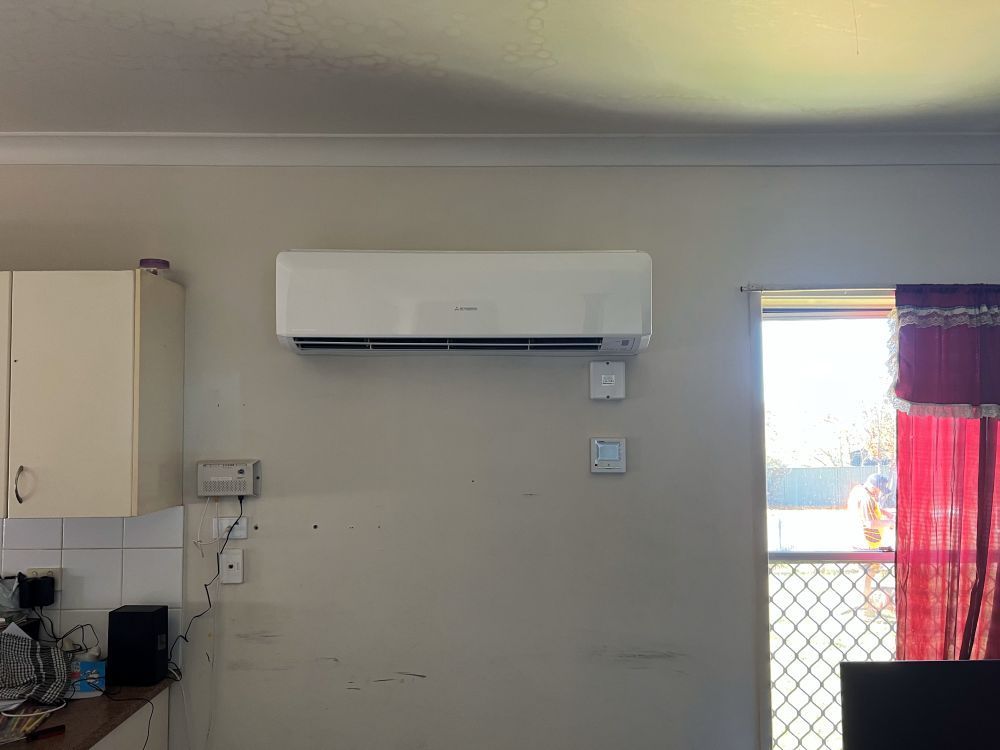 A Kitchen With a Window and a White Air Conditioner on the Wall — JW Electrical, Air & Solar Pty Ltd in Kew, NSW