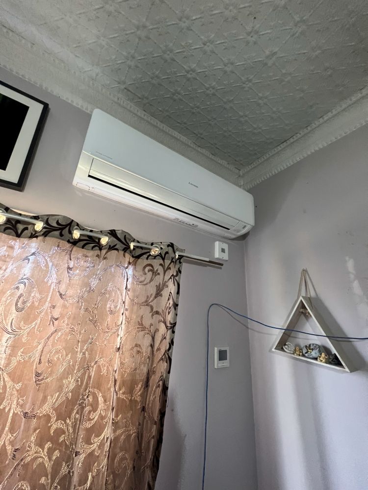 A room with a window and a triangle shelf on the wall.— JW Electrical, Air & Solar Pty Ltd in Kew, NSW
