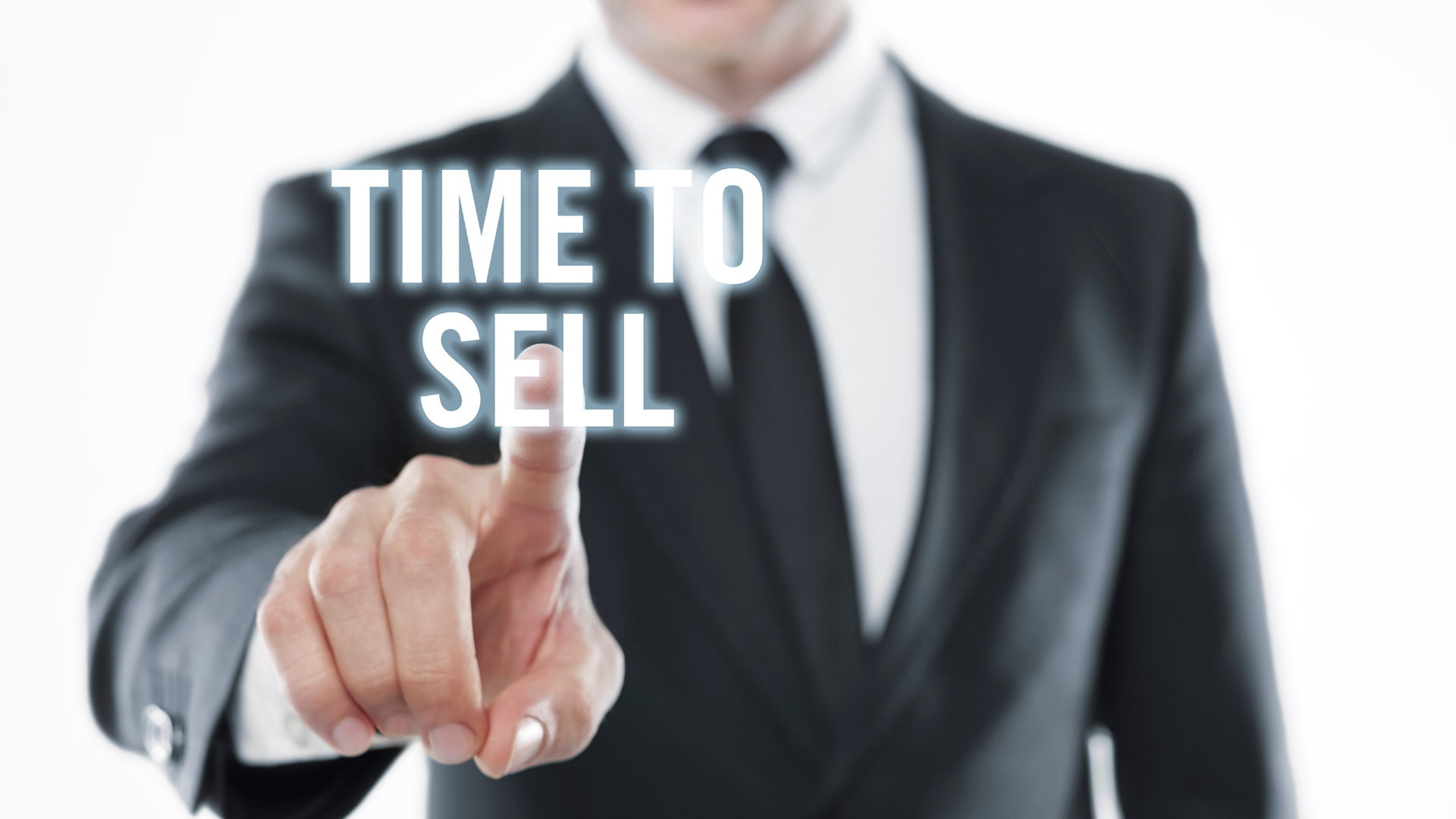 Businessman in a black suit pointing forward with “TIME TO SELL” text overlay.