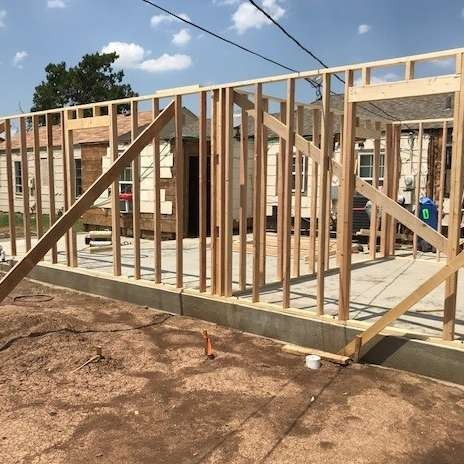 Wood frame construction of a building with a concrete foundation.