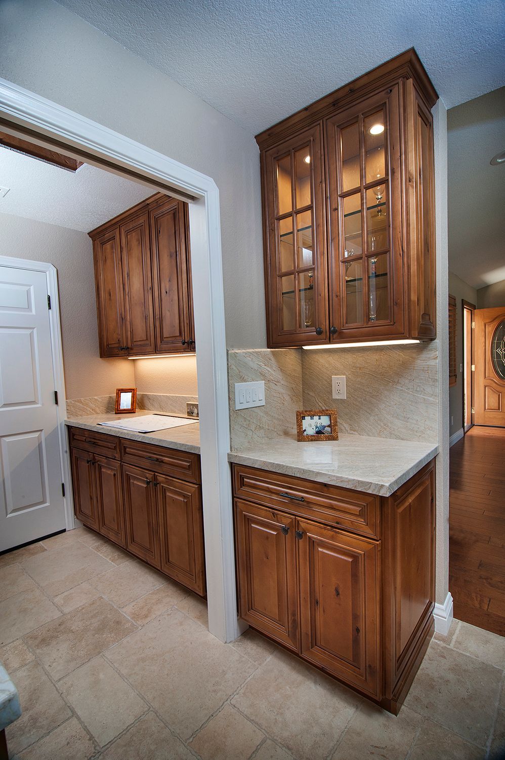 Kitchen with wood cabinets, granite countertops, and tile floor.