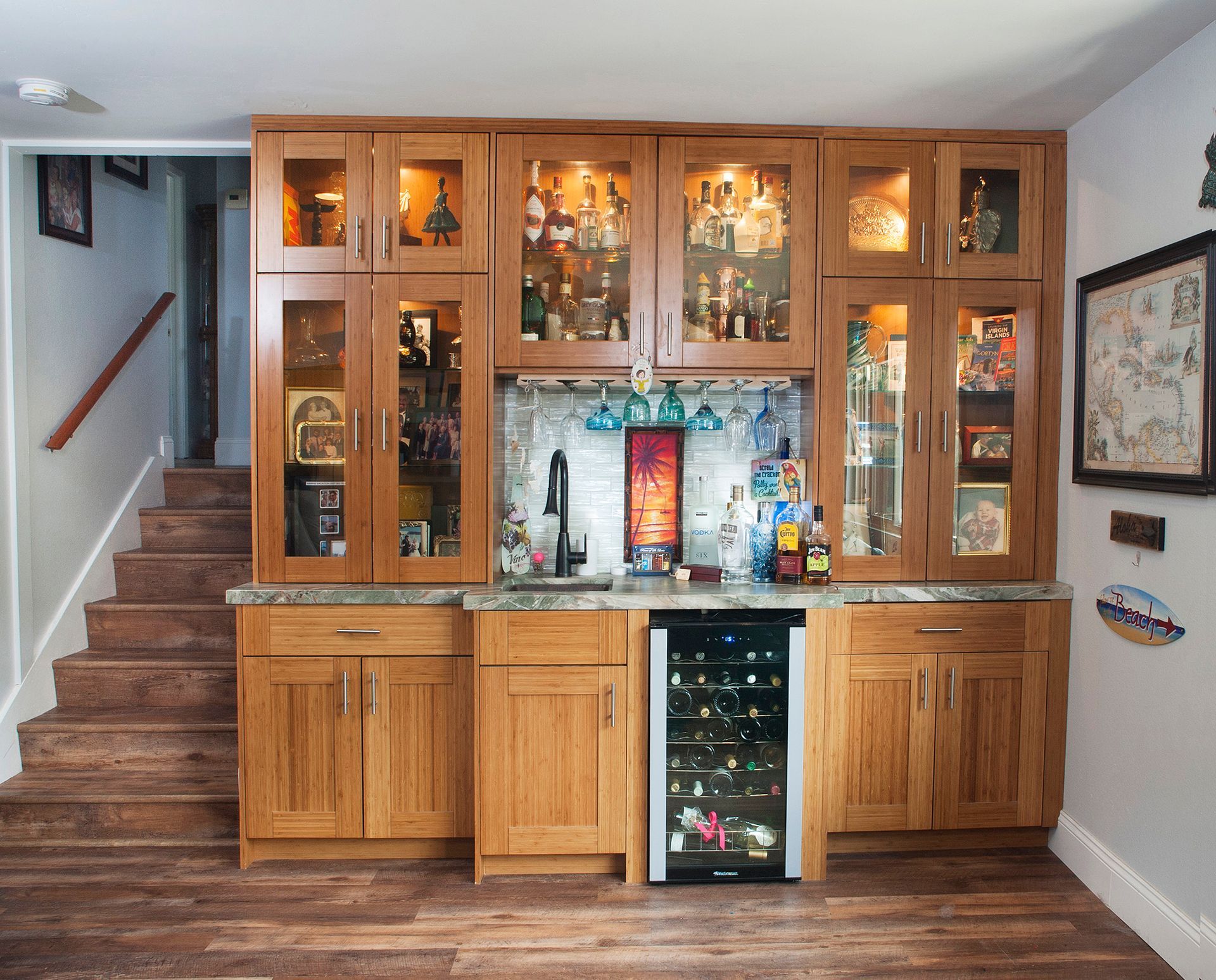 Home bar with wood cabinetry, granite countertop, and wine fridge.