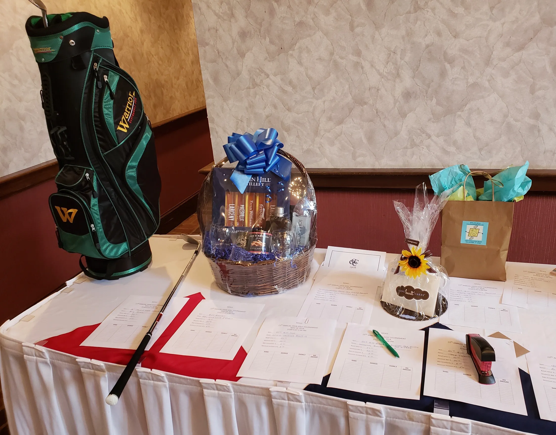 A table with a golf bag and a basket on it