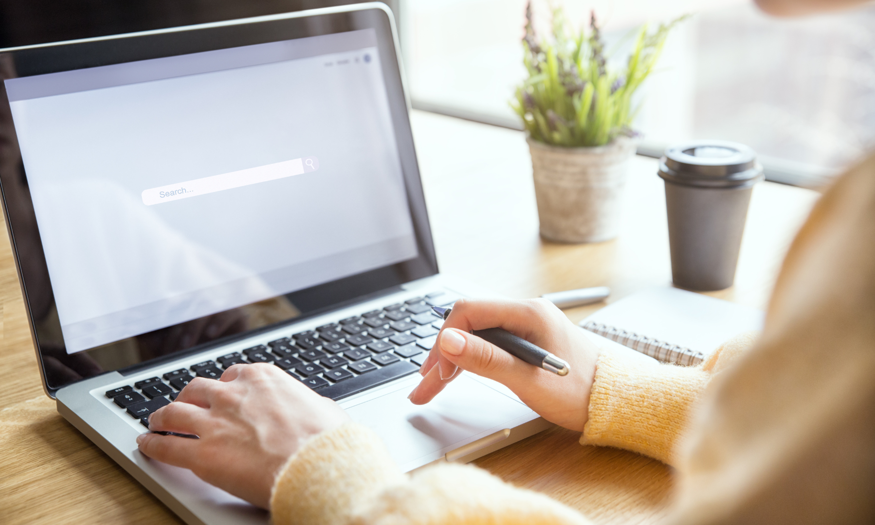 A person is typing on a laptop computer.