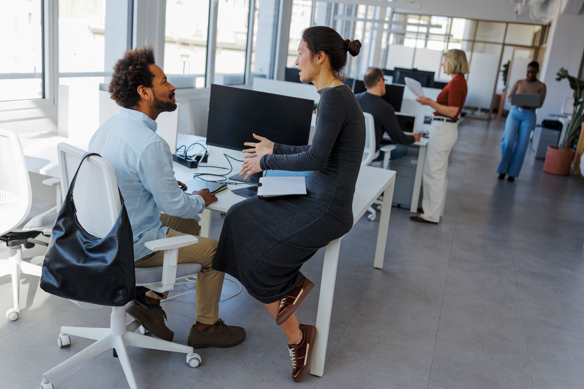 Colleagues collaborating in a clean, modern office.