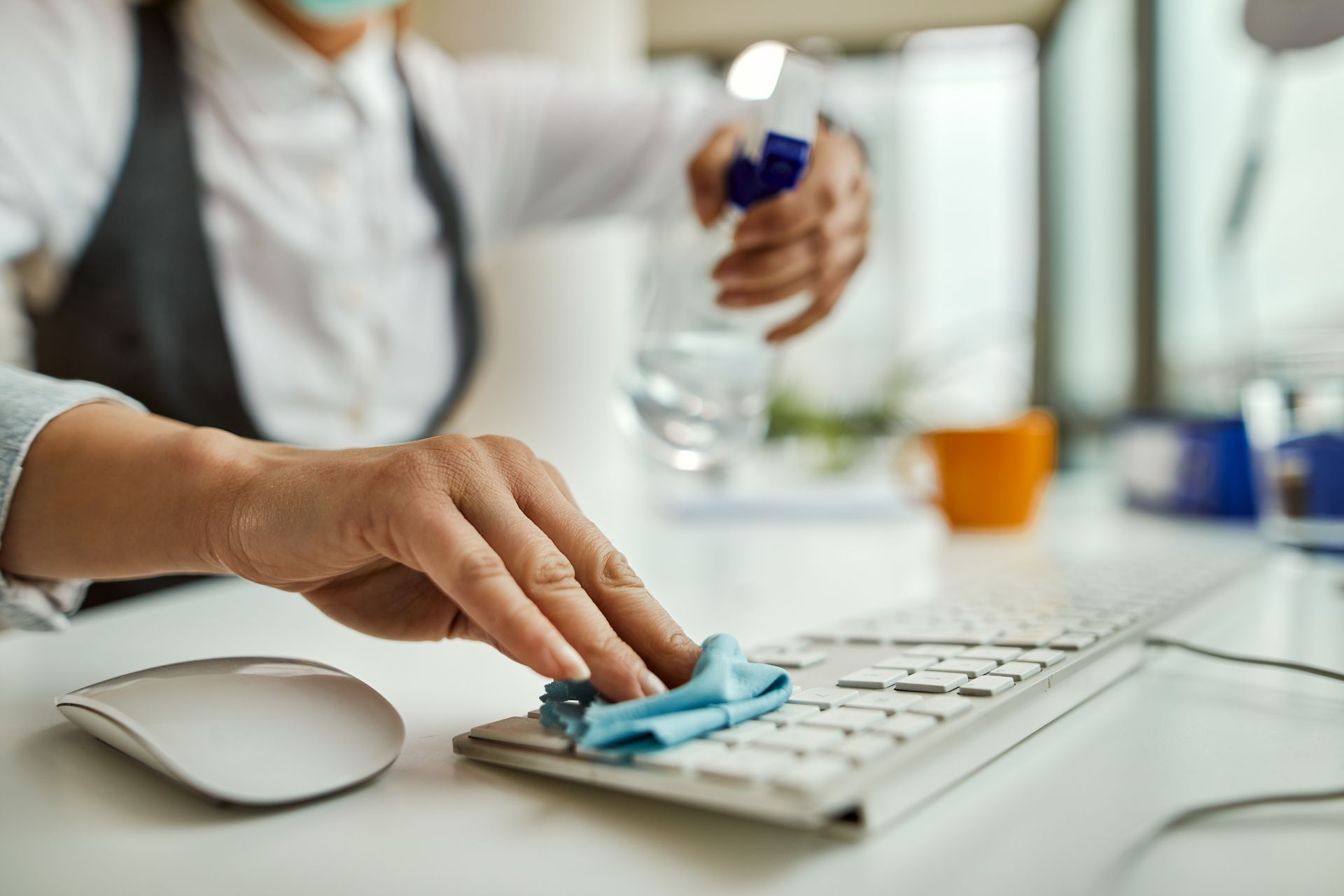 A nurse is cleaning a table in a hospital room.