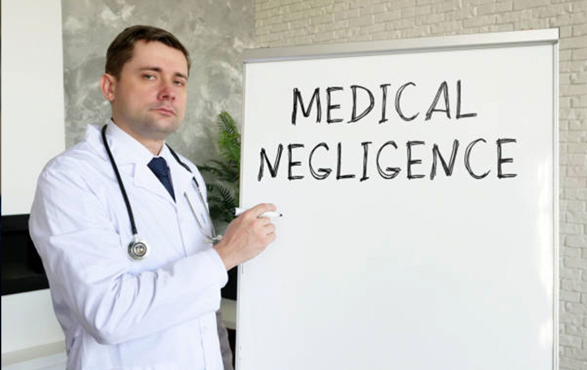 A doctor is standing in front of a whiteboard with the word medical negligence written on it.